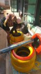 Ayeah Leonette piling collected used tyre from running stream in Ntauru quarter, Bamenda Northwest Region, Cameroon.