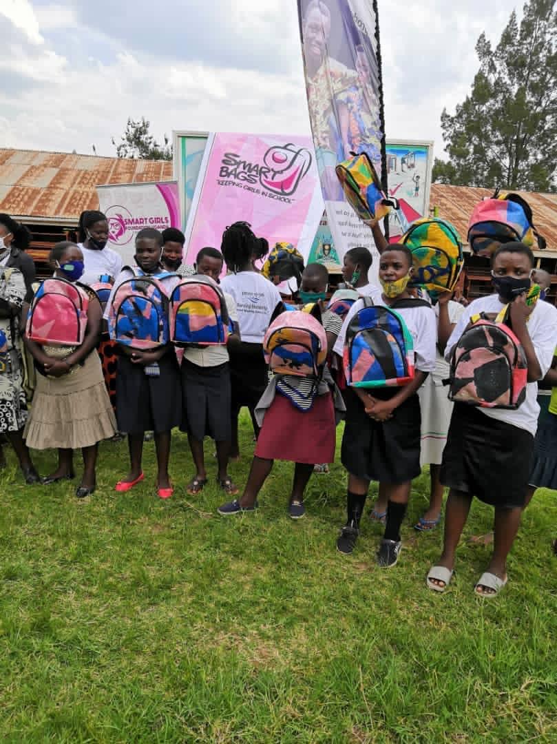 School girls pose with the backpacks donated by Reform Africa to rural schools.