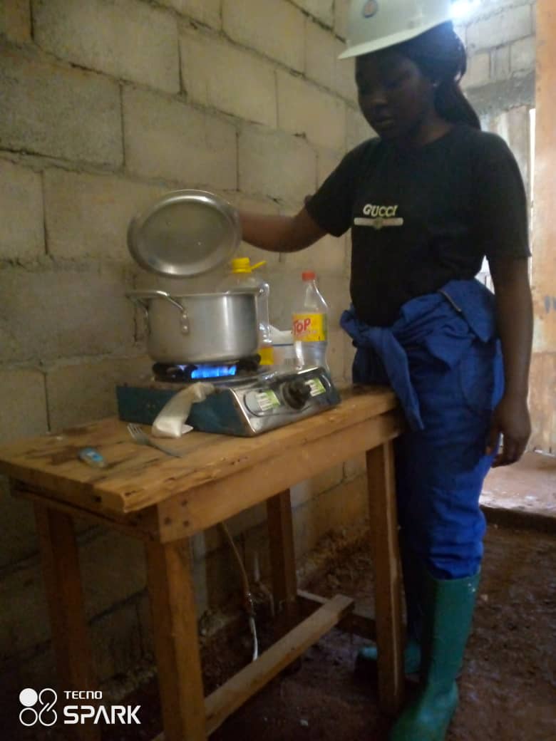 Beneficiary using biogas to cook