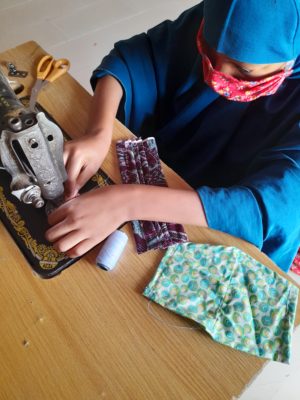 Aisha Ishaq busy on her sewing machine. Photo/Nusaiba Ibrahim/AWiM