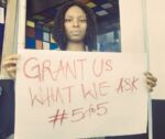 Chinemerem Onuorah, holding a placard, just before stepping out for the EndSARS protest in Abuja Photo Credit: Chinemerem Onuorah